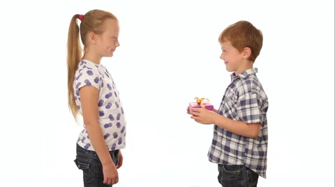 Cute little boy giving a present to the girl, white background Stock Footage 65776471