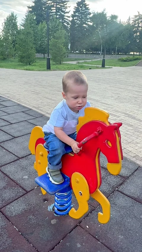 Cute little boy having fun on outdoor playground. Spring summer active sport  Stock Footage 279310953