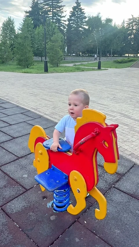 Cute little boy having fun on outdoor playground. Spring summer active sport  Stock Footage 279310987