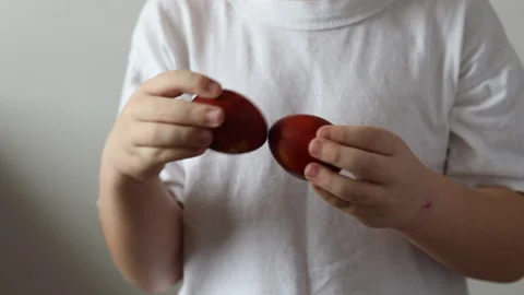 A cute little boy is holding two colorful easter eggs. Easter concept Stock Footage 147452748