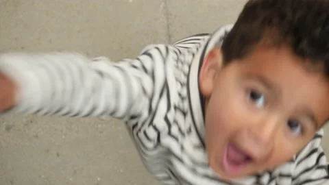 A cute little boy jumping to the camera real lifestyle footage Vídeo Stock 131865396
