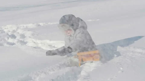 Cute little boy kid playing with toy truck and snow in winter 動画素材 101568053