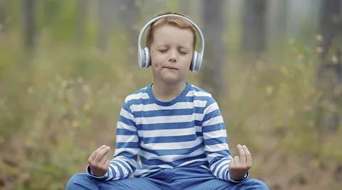 Cute Little Boy Meditating In The Forest Stock Footage 61582053