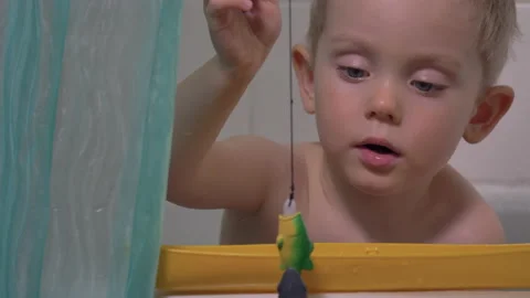 Cute little boy playing in the bathroom, catching fish. Stock Footage 130670541