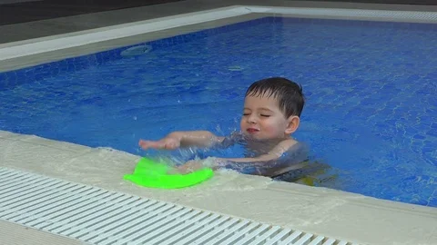 Cute little boy is playing with a cap for swimming Video stock 73447315
