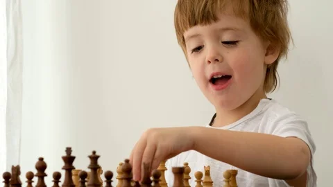 Cute little boy playing chess Stock Footage 127705191