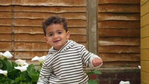 A cute little boy playing games and dancing real lifestyle footage Vídeo Stock 131865635