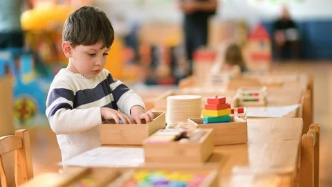 Cute Little Boy Playing at Kindergarten with Construction Toy Stock Footage