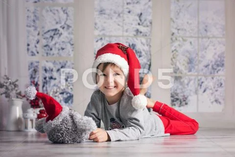 Cute little boy, playing with little fluffy owl toy at home Stock Photos