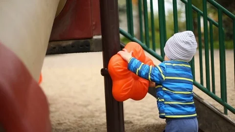 Cute, little boy playing with plastic toy on the playground Stock Footage 75215872