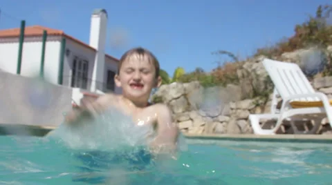 Cute little boy playing in the pool on summer vacation Stock Footage 32936292