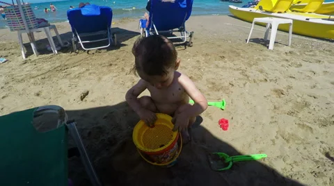 Cute Little Boy Playing with Sand on the Beach Stock Footage 61350262