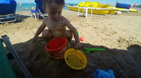 Cute Little Boy Playing with Sand on the Beach Video stock 61351454
