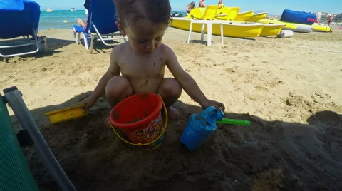 Cute Little Boy Playing with Sand on the Beach 動画素材 61354225