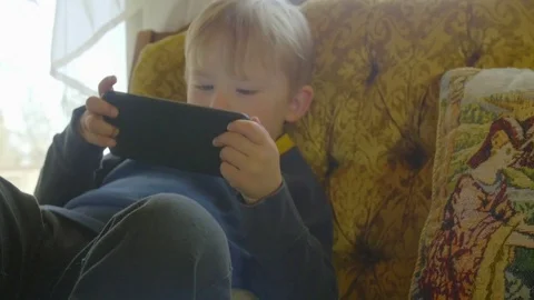 Cute little boy plays on tablet Stock Footage 76546857