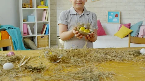 Cute Little Boy Posing with Easter Eggs in Hay Nest Stock Footage 106069101