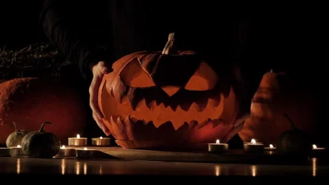 Cute little boy preparing Jack O' Lantern pumpkin for Halloween at home Getti Stock Footage 272459043