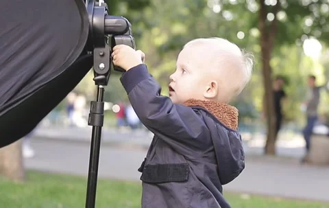 cute little boy sets up a flash for the ... | Stock Video | Pond5