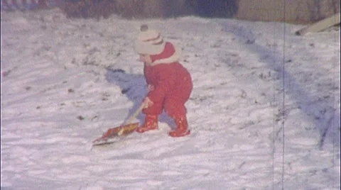 Cute Little Boy Shovels Snow Wintertime Sledding Fun Vintage Film Home Movie 323 Stock Footage