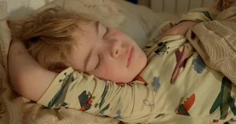Cute Little Boy Sleeping Face. Kid Sleeps on Bed in the Morning in Bedroom. 4K Stock-Footage 299680695