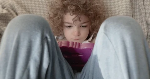 A cute little boy slouched back or reclining on a sofa drawing Stock-Footage 115961813
