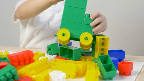 Cute little boy (toddler, two years old) is playing with Building bricks Видео 102467684