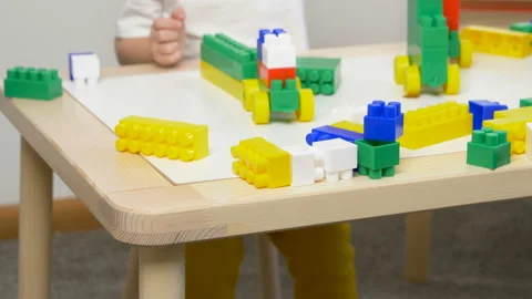 Cute little boy (toddler, two years old) is playing with Building bricks Stock Footage 102479007