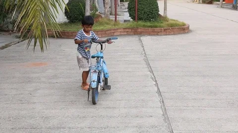Cute little boy try riding bicycle Stock Footage 73710055