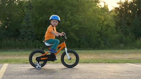 Cute little boy ( two years old child) is riding bike Stock Footage 113648970
