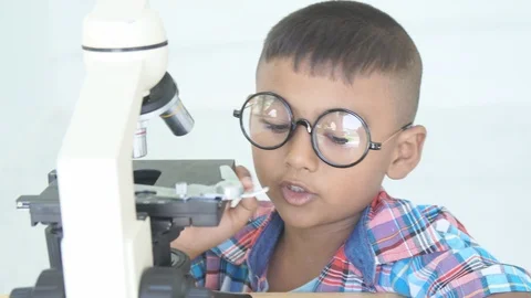 Cute little boy use microscope Stock Footage 91878464