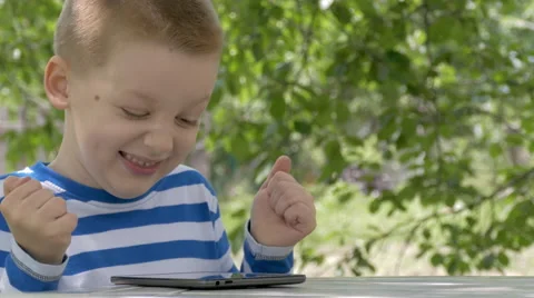 Cute Little Boy Using A Tablet And Wins A Game Stock Footage 63131896