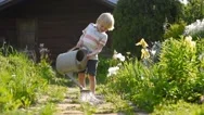 Cute Little Boy Watering Plants And Having Fun In The Garden Stock Footage
