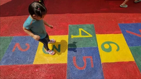 Cute little child learning to play hop scotch Stock Footage 158863302