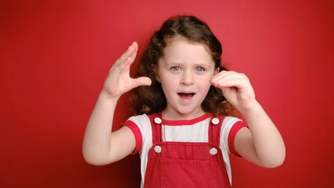 Cute little curly girl posing showing blah blah gesture ja jaja hands Stock Footage