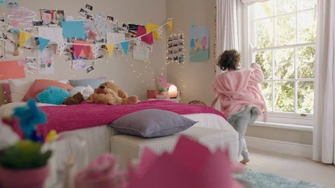 Cute little girl dancing in bedroom looking out window having fun enjoying Stock Footage 111729263
