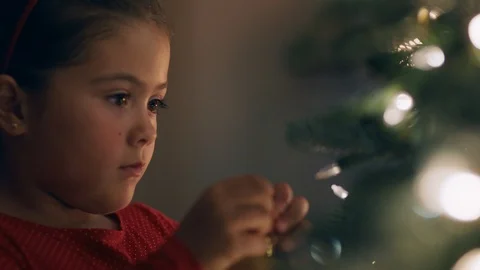 Cute little girl decorating christmas tree with beautiful ornaments and baubles Stock Footage 113249280