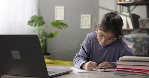 Cute little girl e-learning online using app or website on digital tablet Stock Footage 284666908