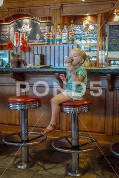 Cute Little Girl Enjoying Ice Cream Stock Photos