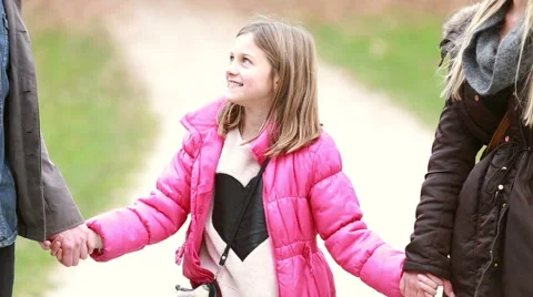 Cute little girl holding hands with parents and laughing Stock Footage 59554455
