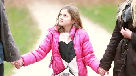 Cute little girl holding hands with parents Stock Footage 59554458