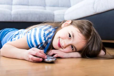 Cute little girl holding a remote control Stock Photos