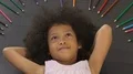 Cute little girl lying with hands clasped behind her head and smiling genuinely HD Footage