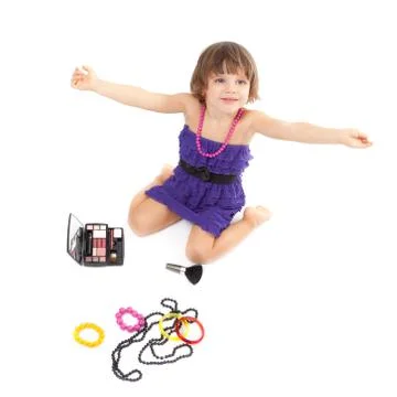 Cute little girl with makeup, necklaces and bracelets is in adulthood Stock Photos