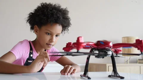 Cute little girl playing with quadcopter Stock Footage