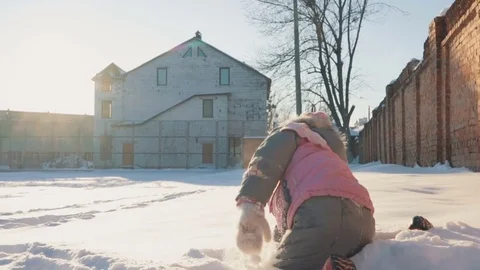 Cute little girl running in the snow, having fun Stock Footage