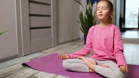 Cute little girl sitting on fitness mat ... | Stock Video | Pond5