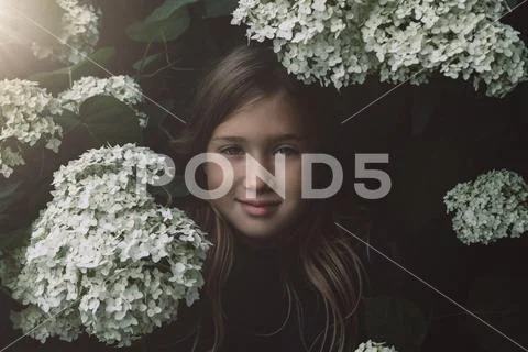 Cute little girl smelling lilac Stock Photos