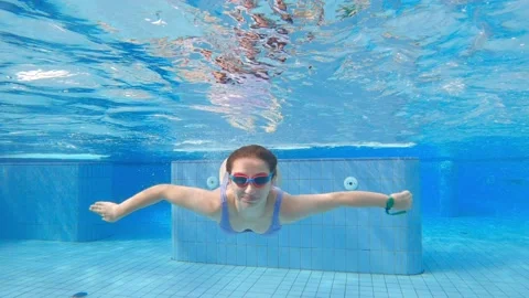 Cute little girl swimming underwater in | Stock Video | Pond5