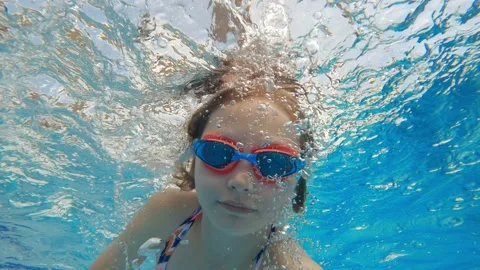 Cute little girl swimming underwater in ... | Stock Video | Pond5