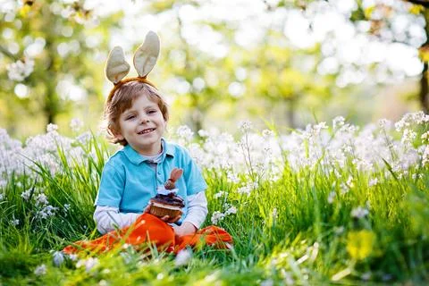 Cute little kid boy with Easter bunny ears celebrating traditional feast. Happy Stock Photos